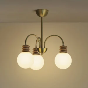 3-head Borello chandelier with frosted glass globes installed in residential bedroom with warm ambient lighting