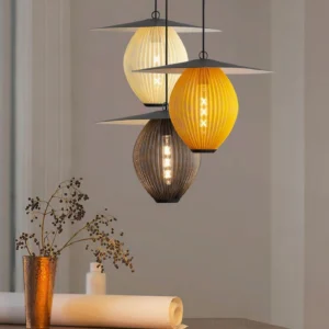 Multiple Boris pendant lights in mixed colors including yellow, dark brown, and beige with black canopies displayed in residential decorative setting