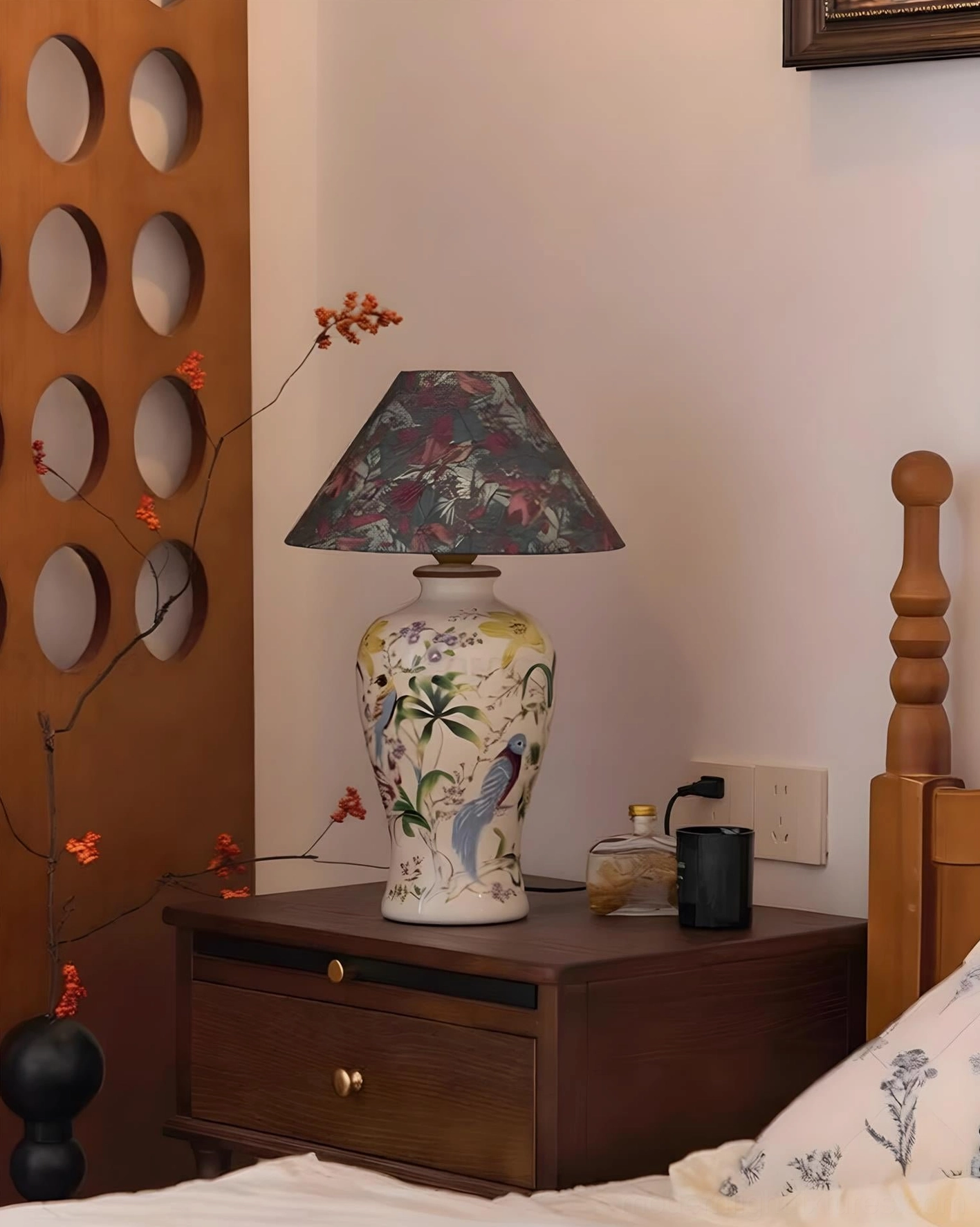 Bedside ceramic table lamp with dark floral fabric shade and hand-painted porcelain base, side angle bedroom nightstand styling
