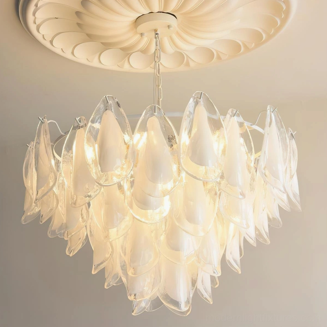 Illuminated botanical glass petal chandelier showing warm light diffusion through layered petals