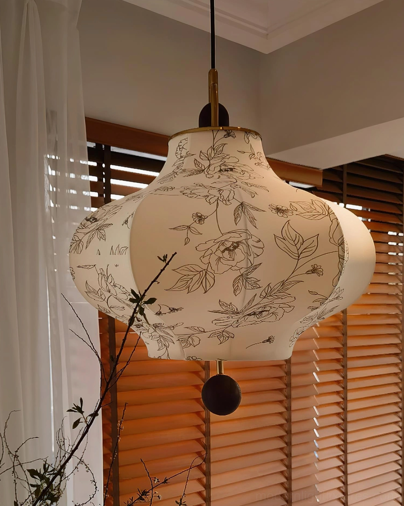 Botanical pendant light showing full floral print fabric and brass hardware