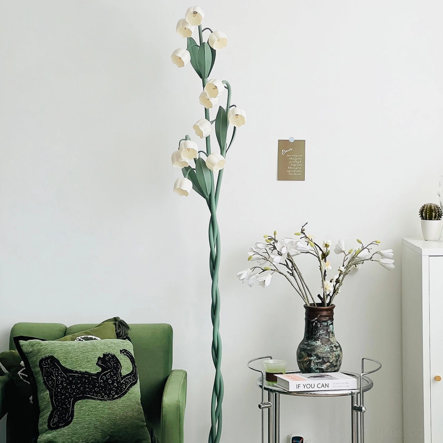 Three-bloom floor lamp in styled room creating botanical ambiance with nature-inspired lighting design
