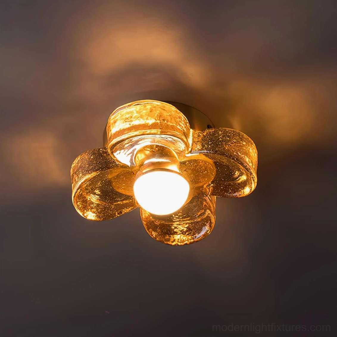 Four-leaf clover amber flush mount ceiling light fixture showing botanical design and warm brass hardware detail