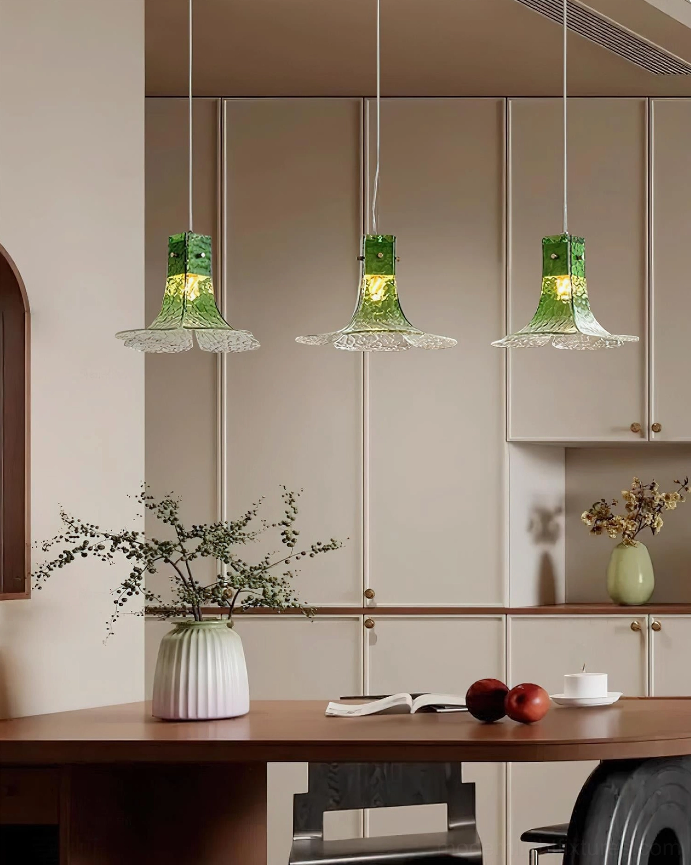 Hand-blown glass botanical pendant light with emerald gradient crown and crystalline petal shade close-up