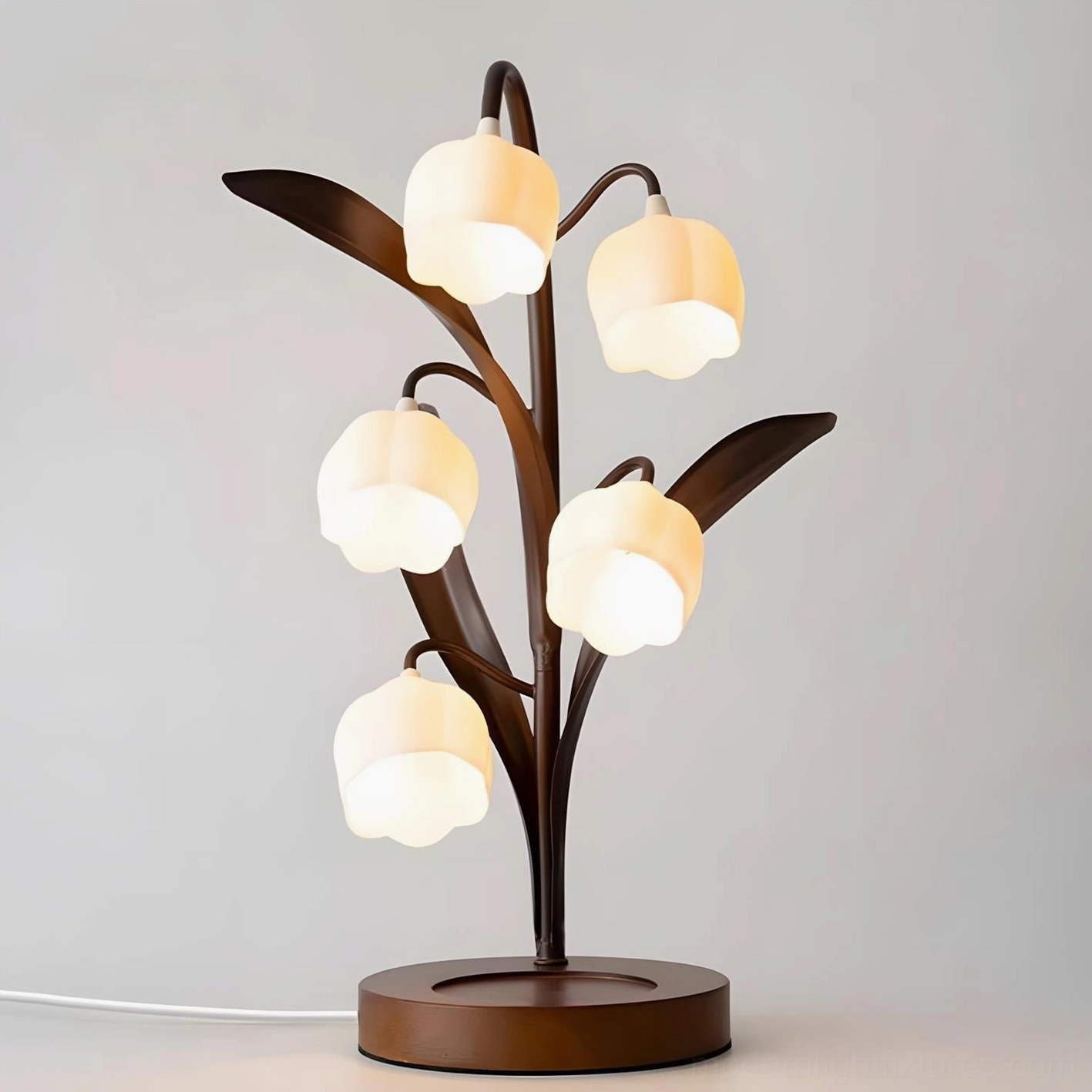 Nature-inspired table lamp positioned on light wood nightstand next to solid wood bed with linen pillow