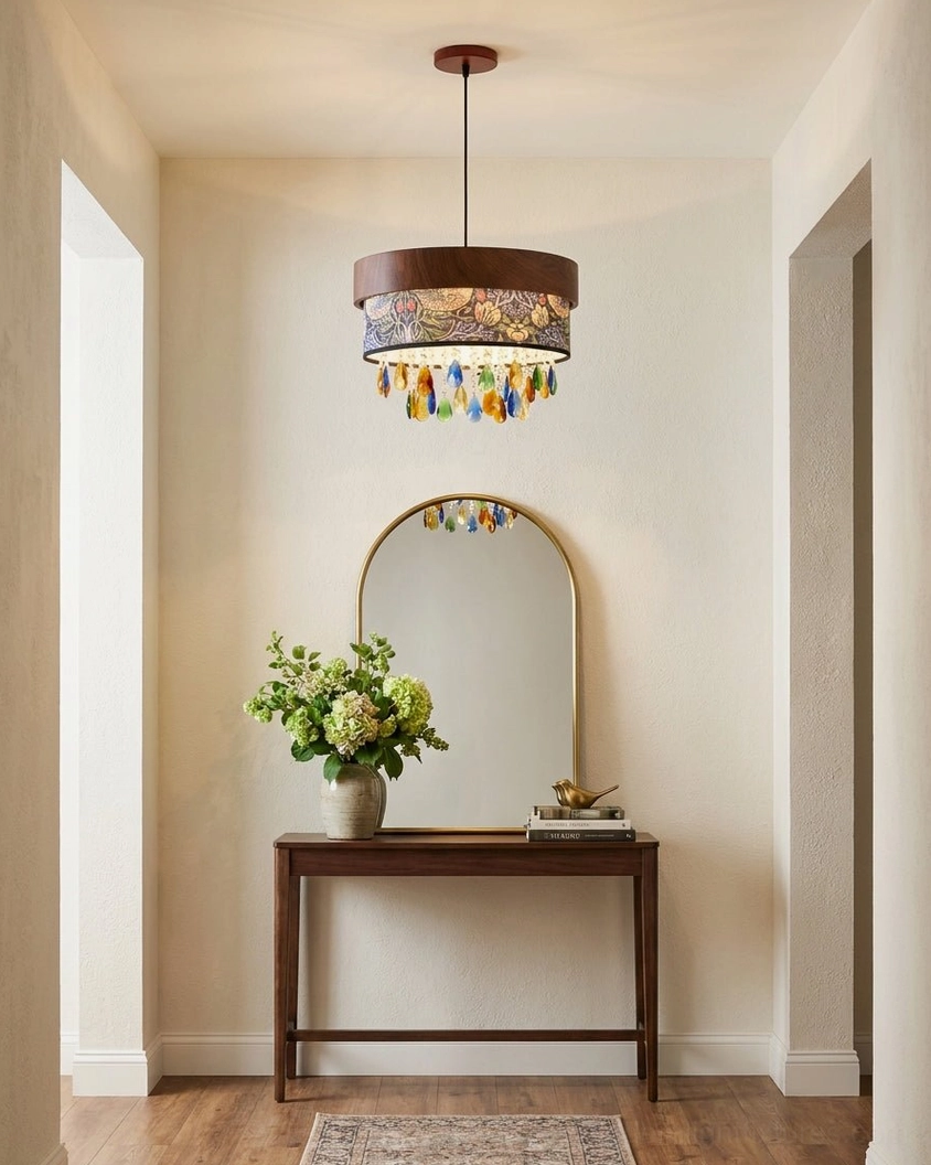 Botanical drum pendant mounted above entryway console table and mirror in modern hallway