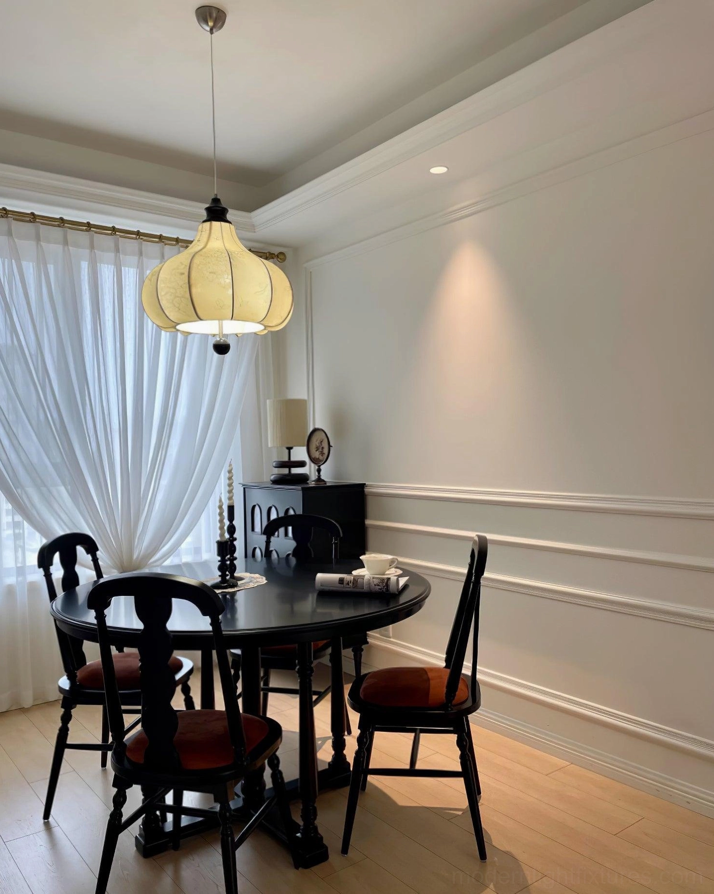 Botanical fabric pendant light showing brass suspension hardware and wood frame detail