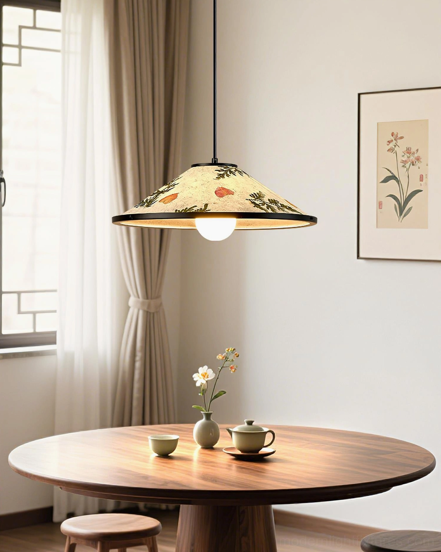 Botanical pendant lamp illuminated above minimalist round wooden dining table in contemporary interior space