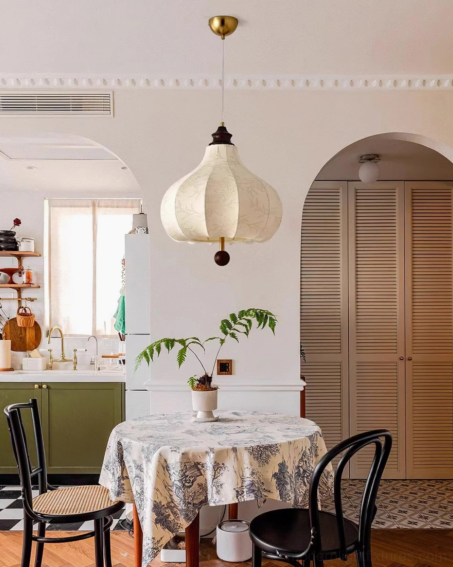 Botanical pendant light in country-style kitchen-dining space with white fabric shade and brass hanging hardware