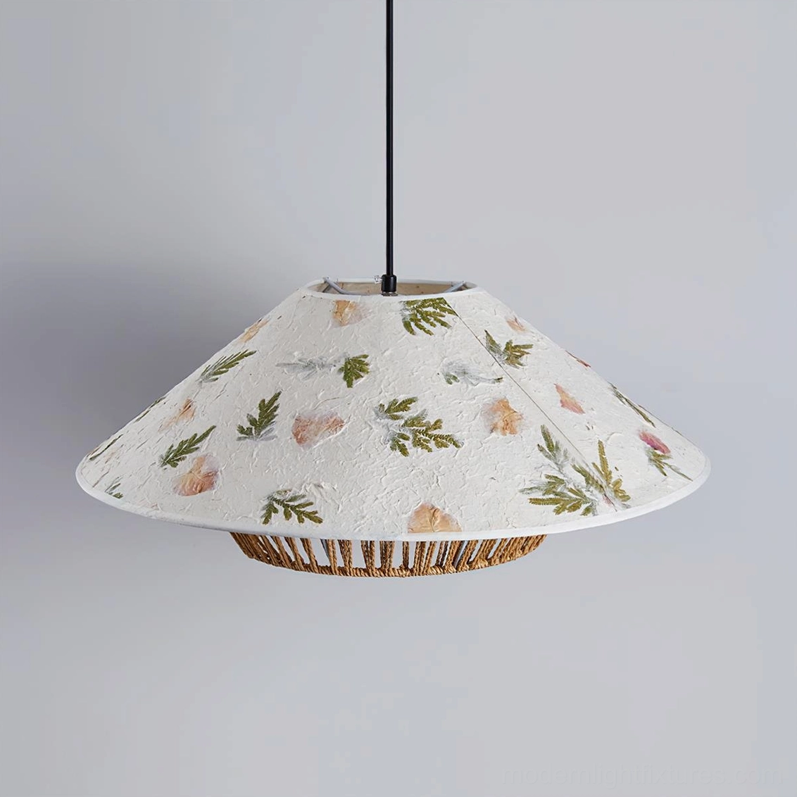 Warm light glow through botanical pressed designs in rattan pendant lamp evening ambiance