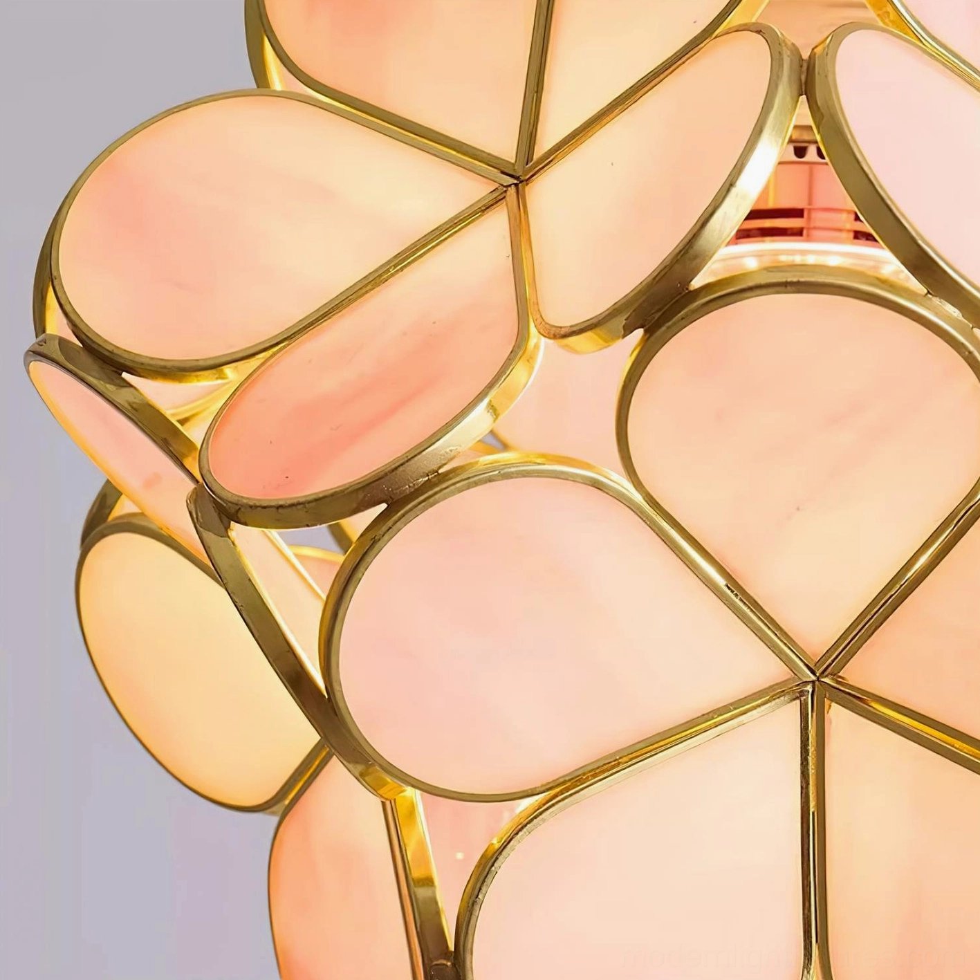 Pink botanical pendant light hanging from wooden ceiling cap, showcasing warm glass petals and metal framework