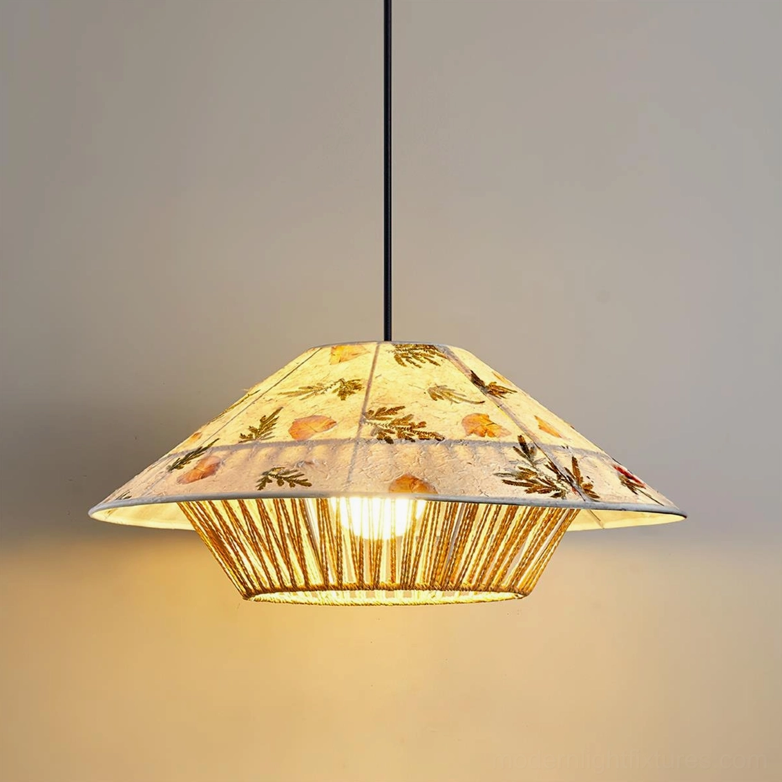 Rice paper pendant lamp with botanical impressions and woven rattan base detail front view