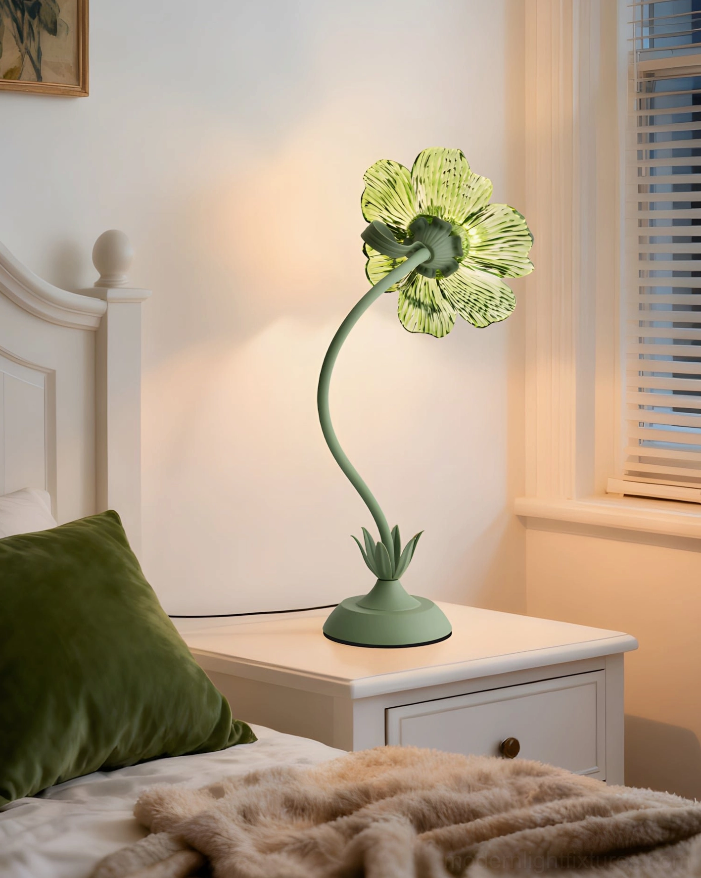 Green table lamp on bedroom nightstand with warm bedside lighting and botanical green bedding decor