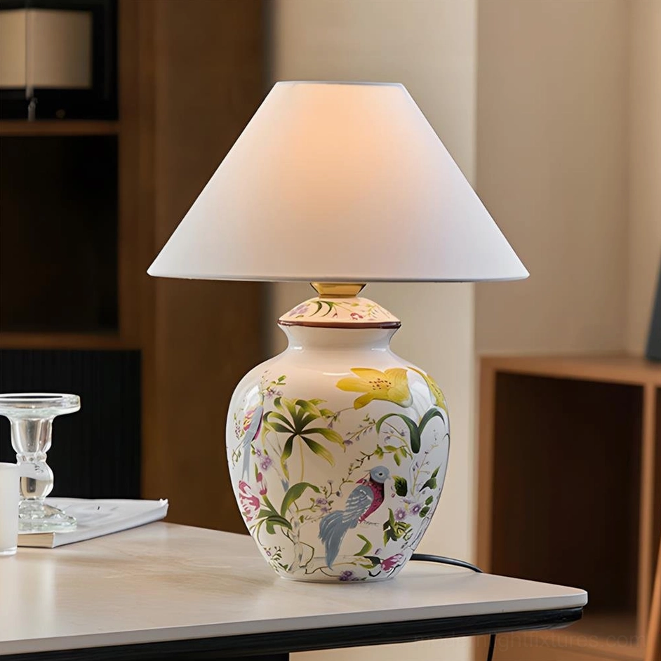 Modern botanical table lamp displayed on home desk with hand-painted ceramic base and fabric lampshade, three-quarter angle view