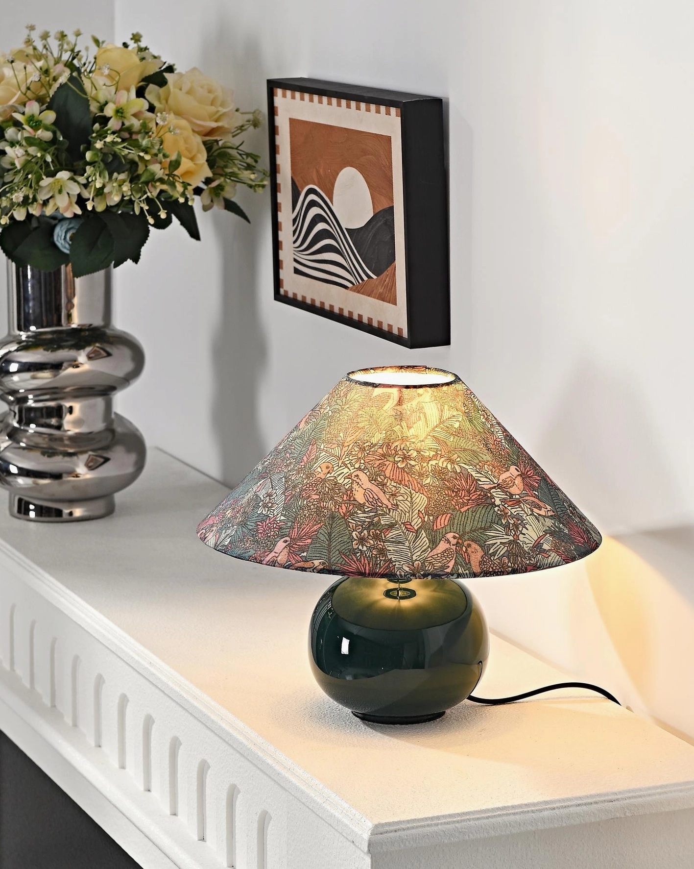 Contemporary botanical table lamp on home office desk providing focused ambient lighting with artistic forest green ceramic base