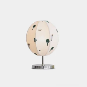 Modern botanical table lamp with nature-inspired fabric shade featuring trees and birds in green and brown, chrome metal base, front studio view