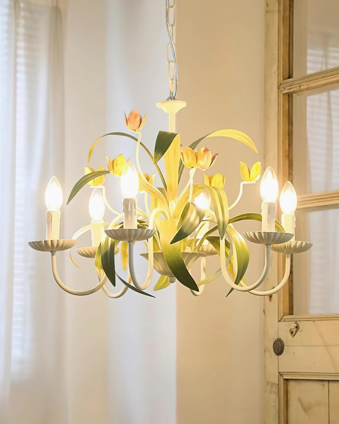 Tulip floral ceiling chandelier illuminated eye-level view with lit candle-style bulbs in vintage home space