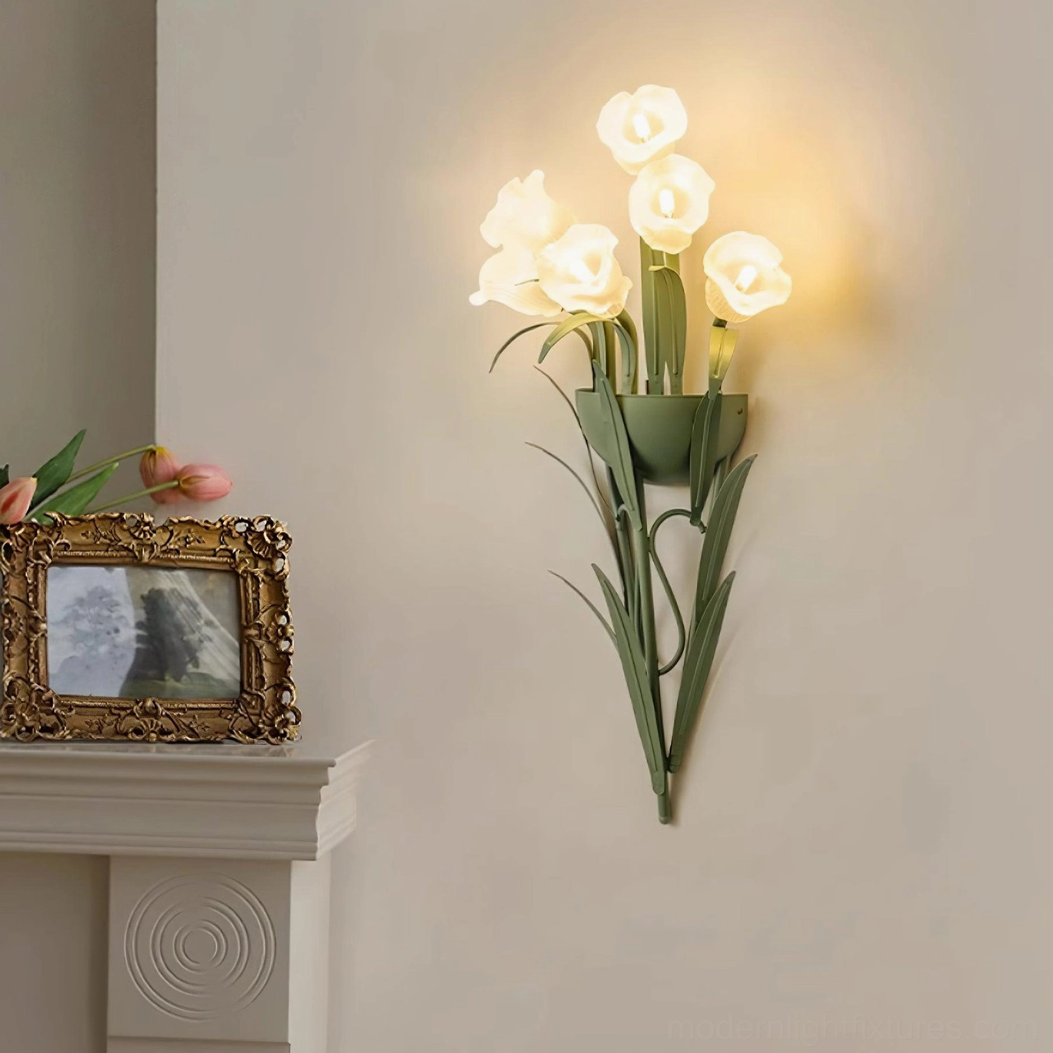 Green botanical wall sconce with white flowers mounted on interior wall, modern floral light fixture installation