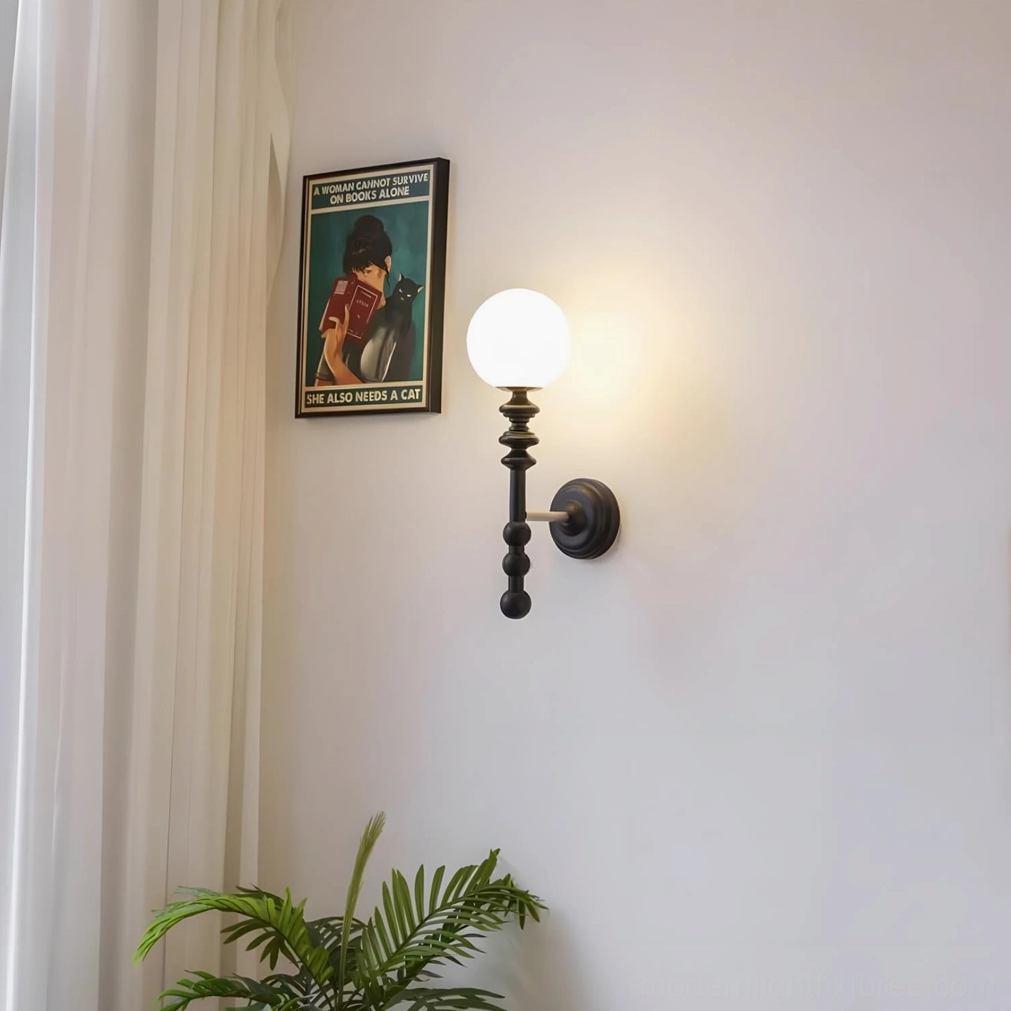Black Bouton wall sconce beside window with curtains and greenery providing soft ambient glow
