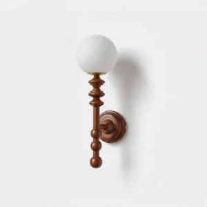 Bouton minimalist wall sconce with spherical frosted glass diffuser and sculpted wooden arm on white wall