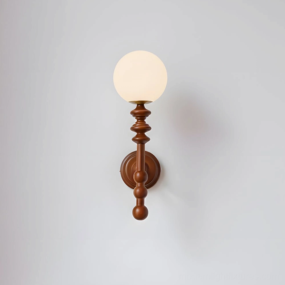Walnut finish Bouton wall sconce with natural wood arm and illuminated frosted glass shade