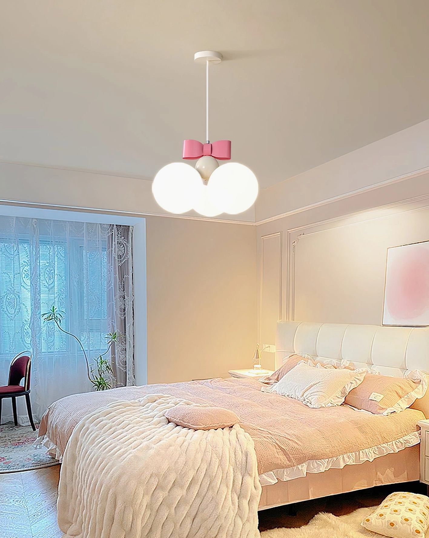 Bowknot pendant light installed in warm neutral bedroom with pink bedding and minimalist decor