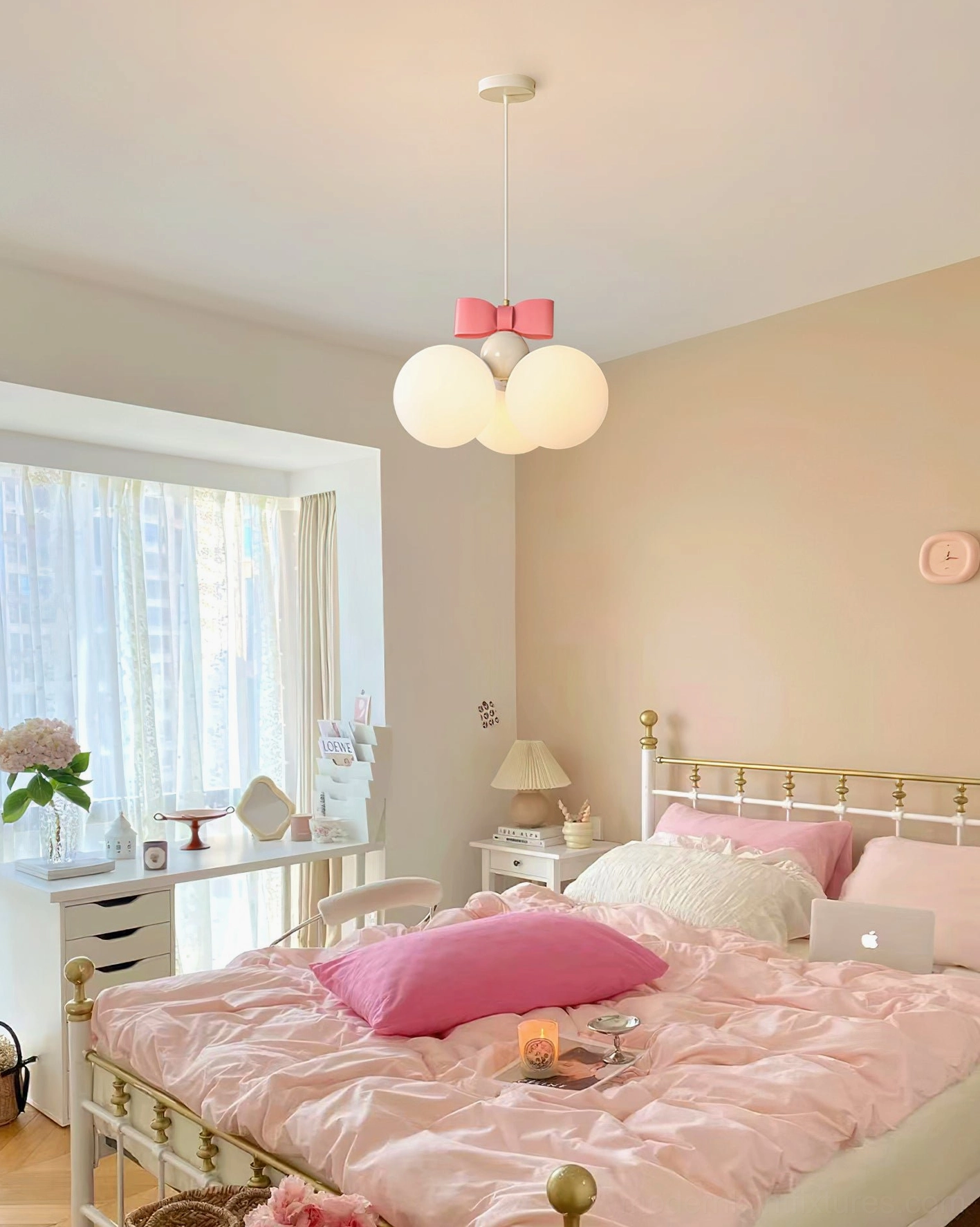 Bowknot pendant light in princess-themed girly bedroom with pink bed linens and study desk