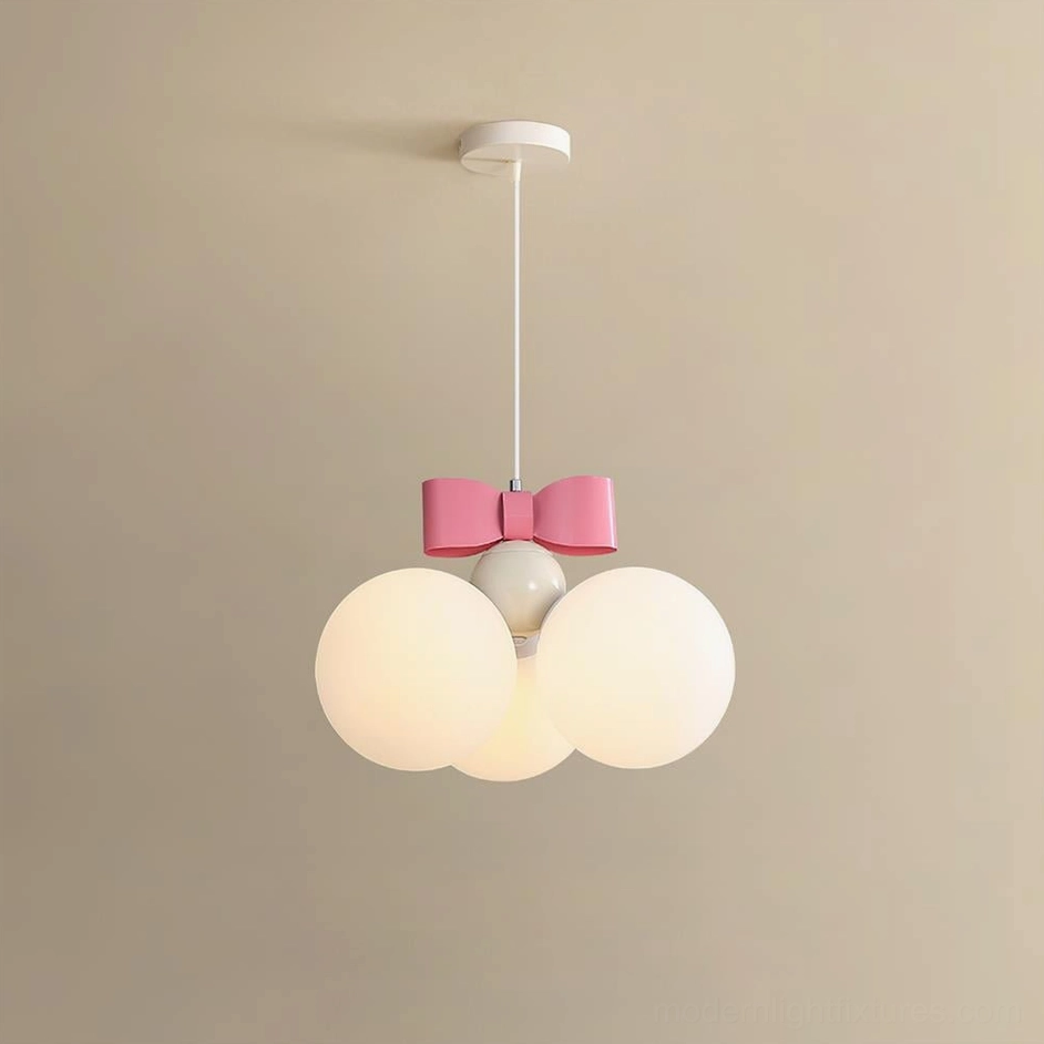 Bowknot pendant light displaying white frosted glass spheres with pink decorative bow at eye level