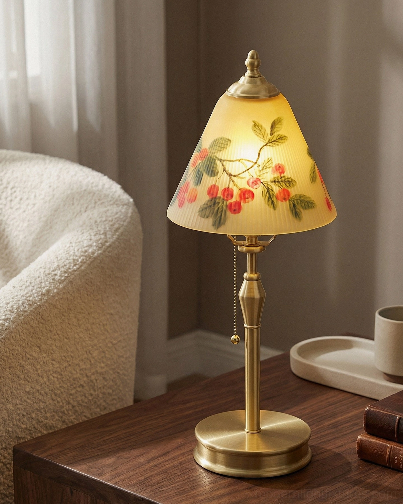 Bramelle vintage brass lamp illuminated on wooden bedroom nightstand with fluffy accent chair and stacked books, cozy bedroom lighting