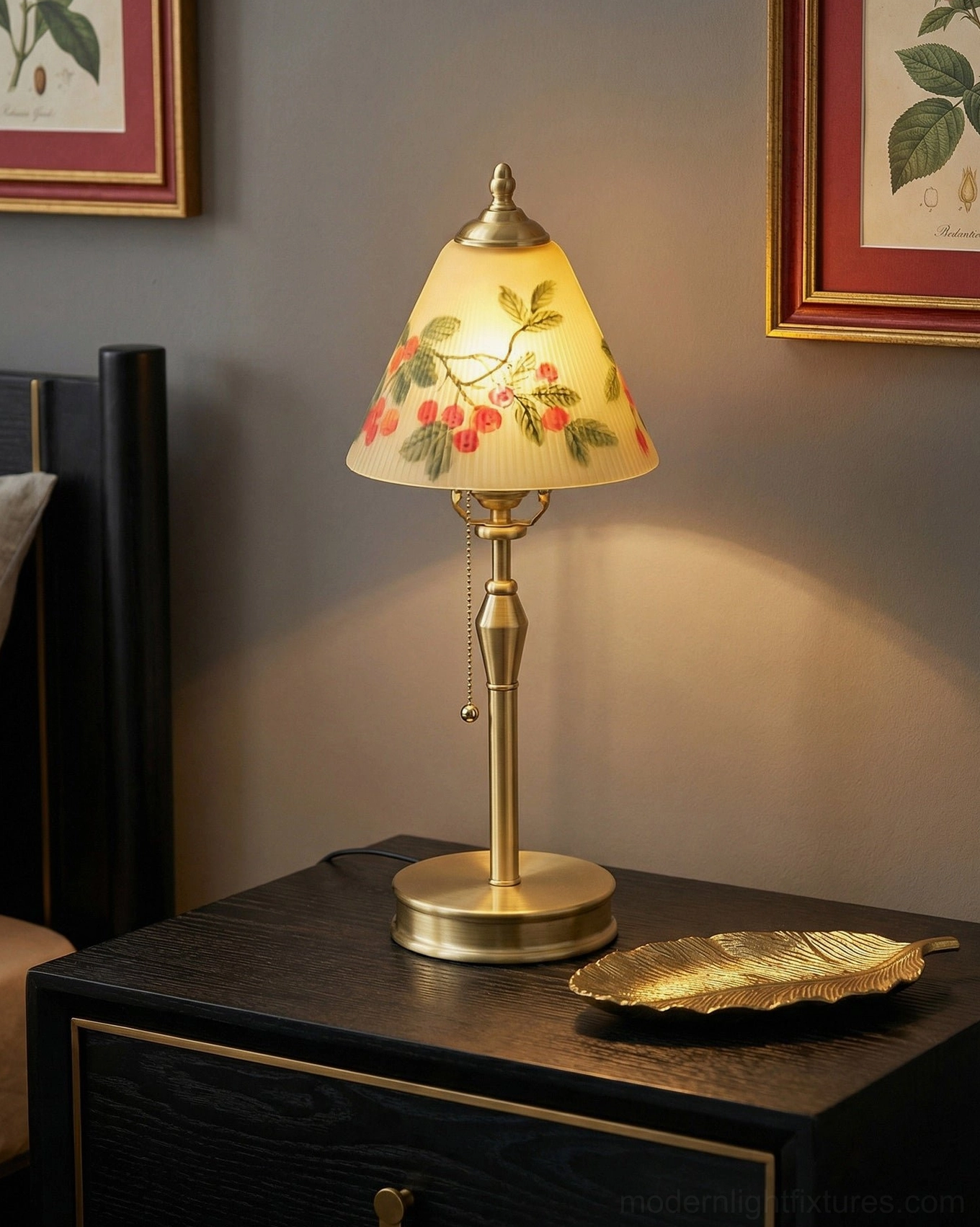 Bramelle hand-painted glass table lamp glowing on dark wood nightstand with framed art and golden decorative tray, bedroom accent lighting
