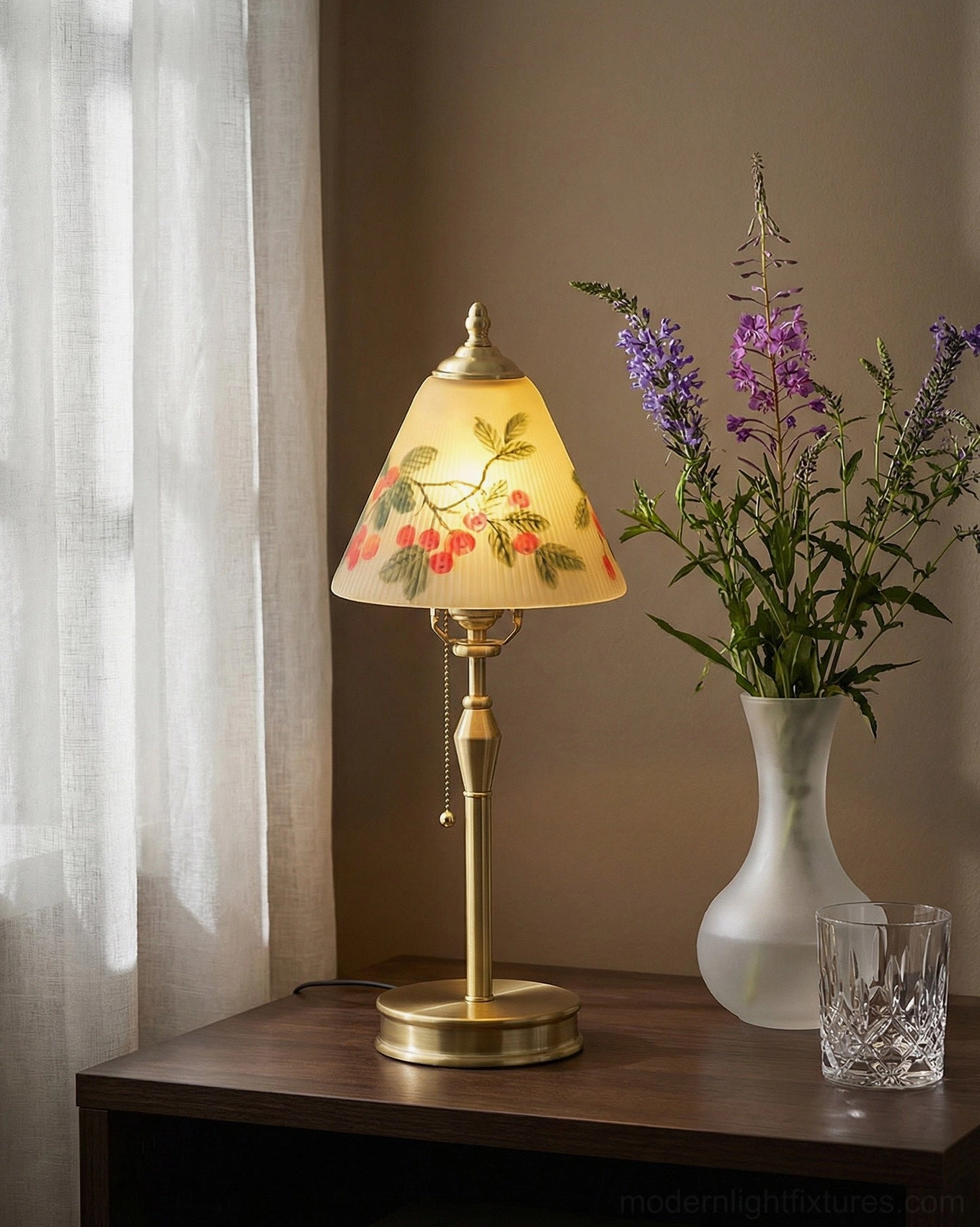 Bramelle vintage table lamp illuminated by window with sheer curtains, white flower vase, and clear glass tumbler on side table