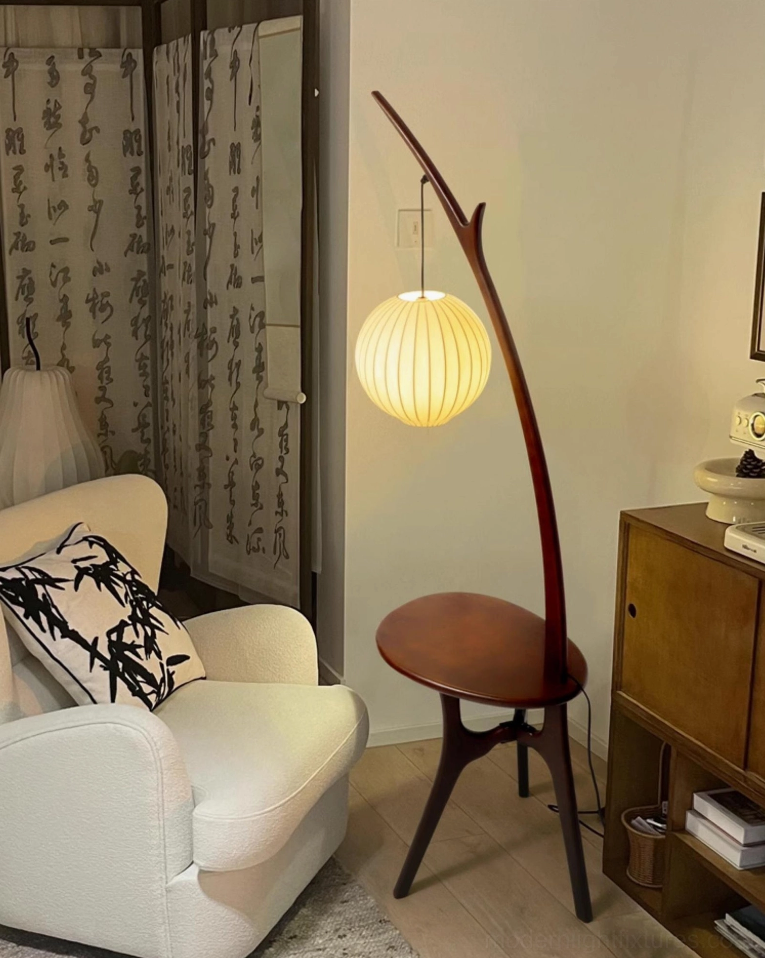 Handcrafted branch floor lamp with integrated side table in warm reading corner with decorative accents