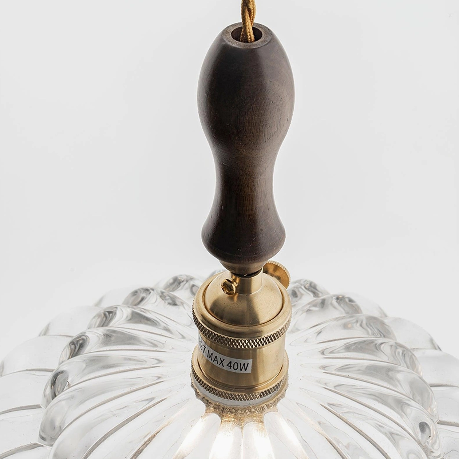 Brandon pendant light mounted installation view, walnut wood handle and brass accents visible