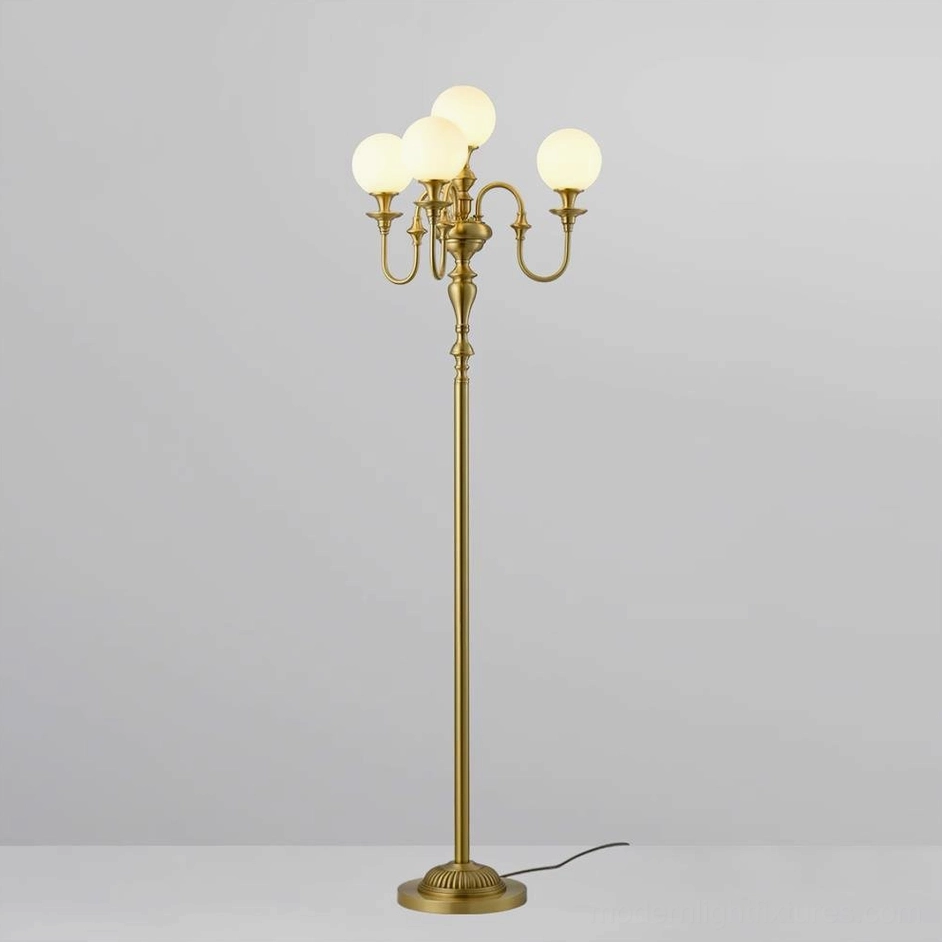 Brass candelabra floor lamp front straight view, lit opal white globe bulbs with brass base and metal pole, studio background
