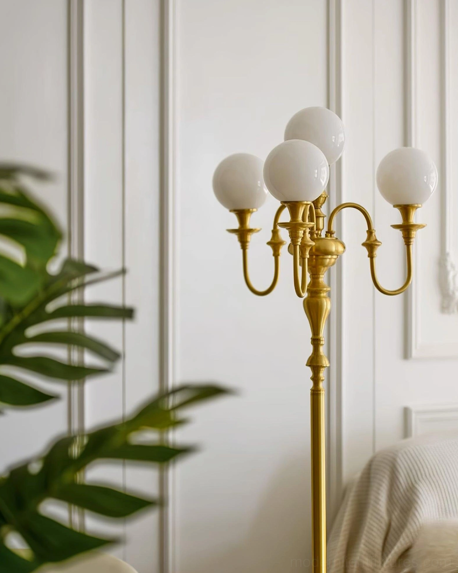 Brass candelabra floor lamp with opal white shades showing warm light diffusion and premium glass quality