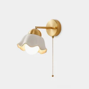 Brass and ceramic wall sconce with ruffled milk-white shade and golden finish - front view studio shot