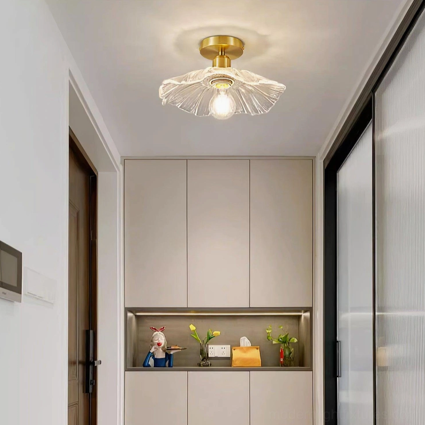 Ruffled glass semi-flush ceiling light fixture demonstrating elegant brass and clear glass material composition