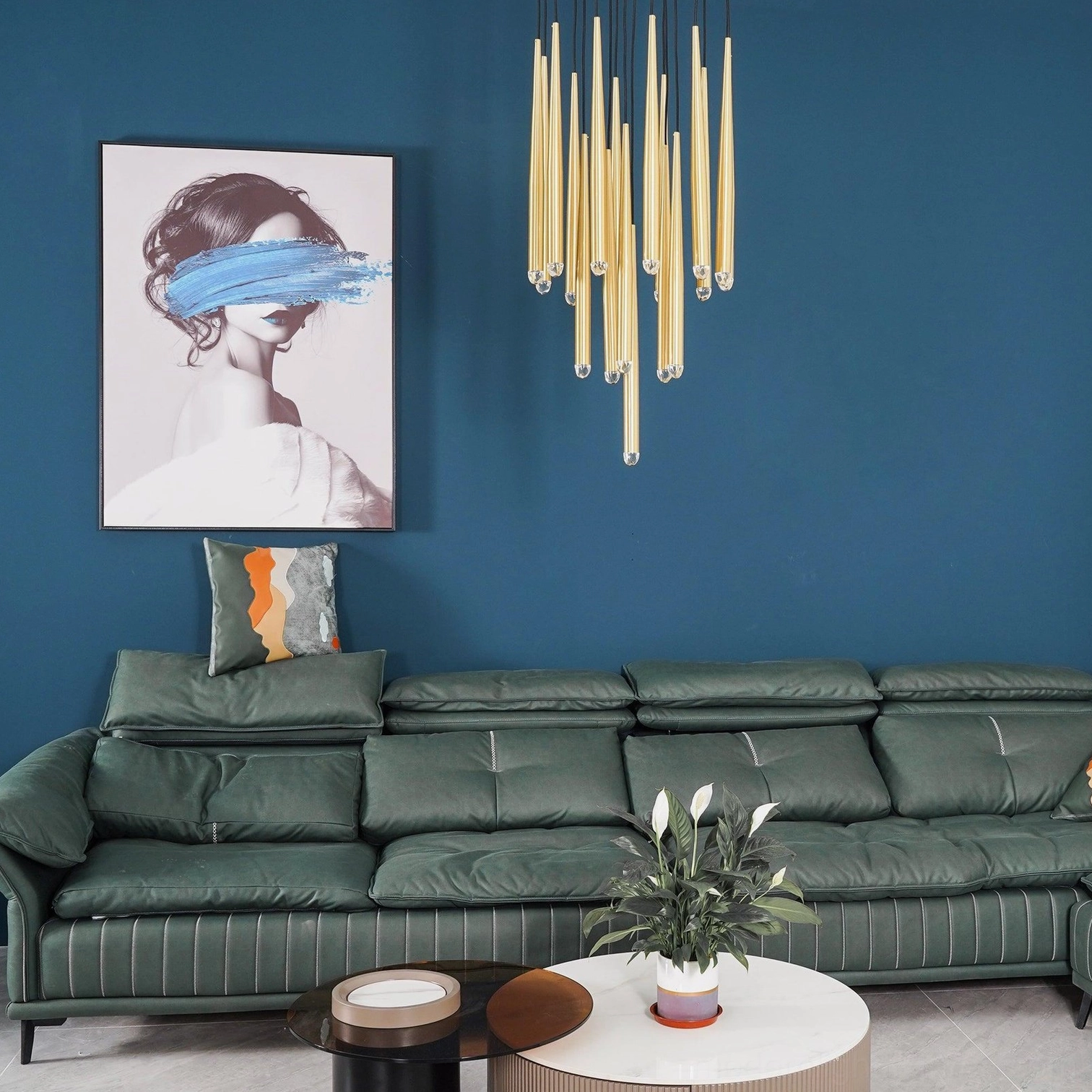 Polished brass cluster chandelier in contemporary living room with teal accent wall