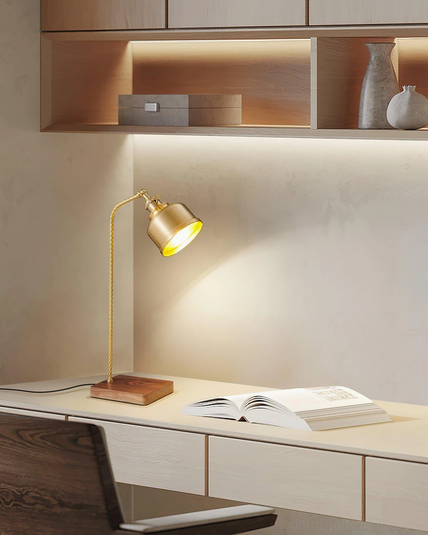 Brass adjustable table lamp on home office desk with open shelving, industrial minimalist workspace lighting