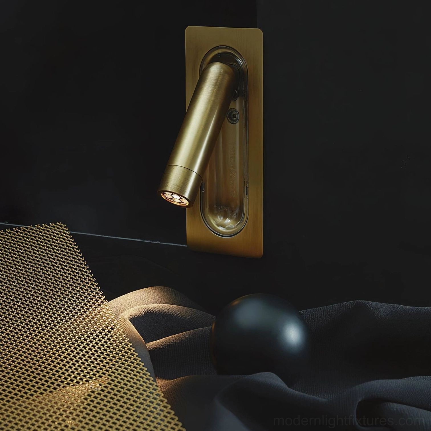 Luxury brushed brass finish recessed wall lamp mounted on dark accent wall with warm ambient light in upscale interior
