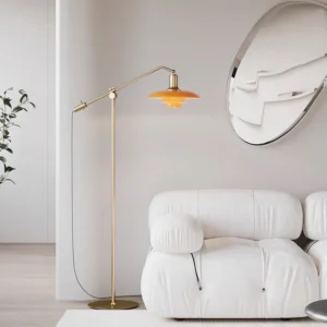 Brass adjustable floor lamp with amber shade displayed in contemporary minimalist living room