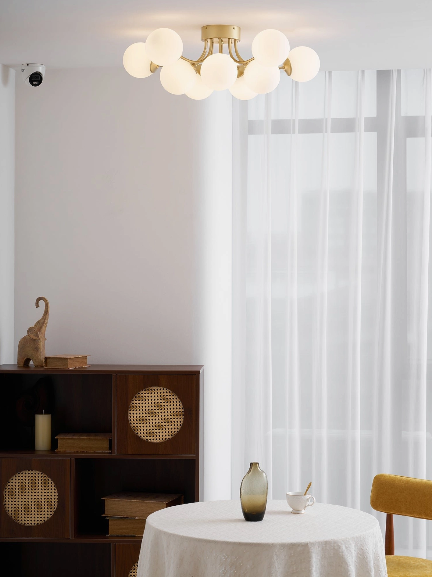 Brass gold multi-head ceiling light fixture displaying spherical glass shade arrangement pattern