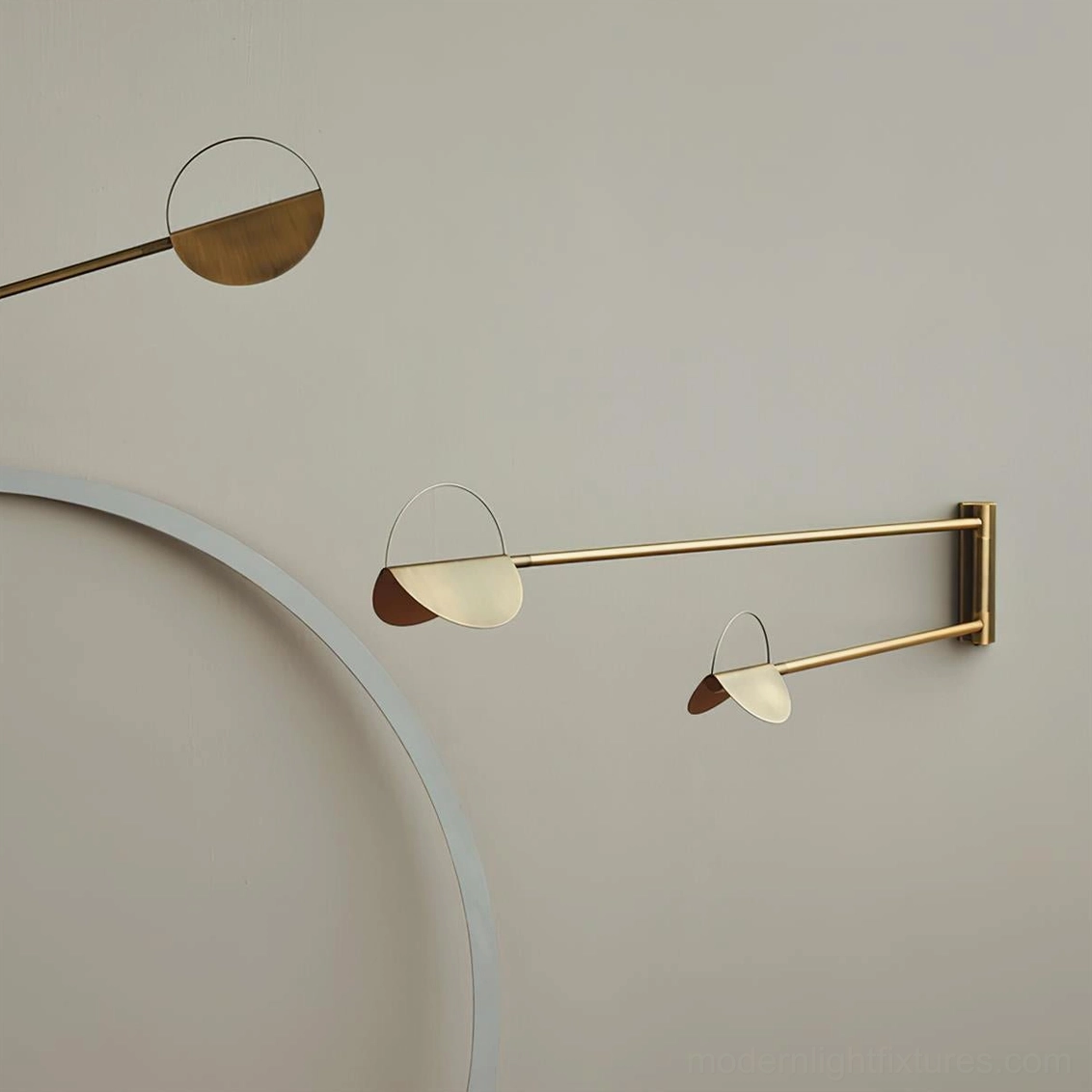 Gold brass finish dual semi-circle wall sconce mounted horizontally on neutral wall with elegant metal framework