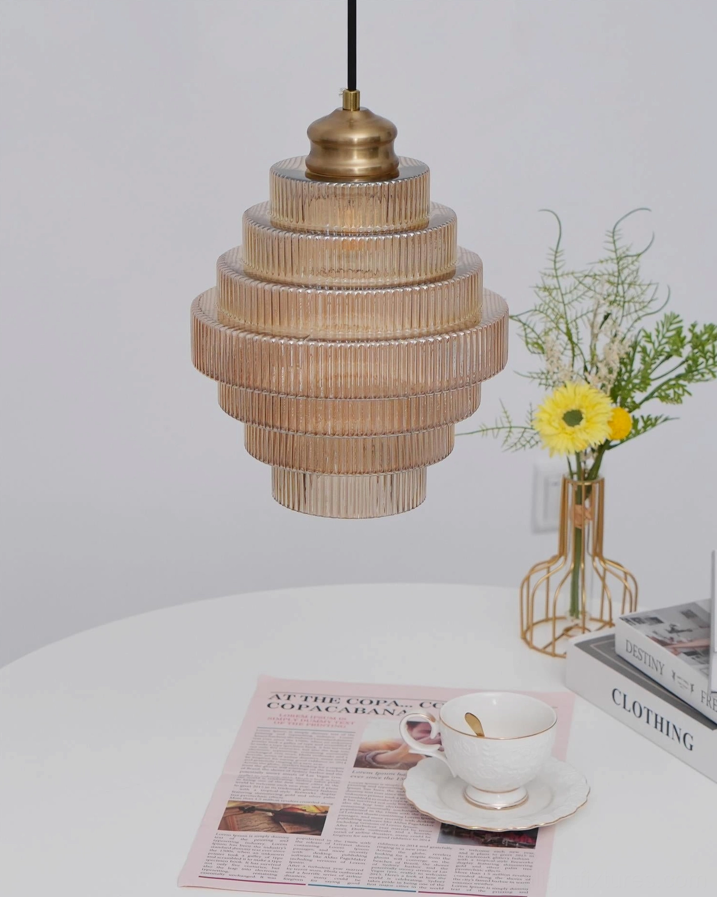 Brass hardware detail of ridged glass pendant light canopy and cord cap, close-up view