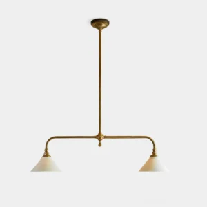 Aged brass two-light linear pendant chandelier with white ceramic conical shades, frontal studio shot showcasing mid-century modern design