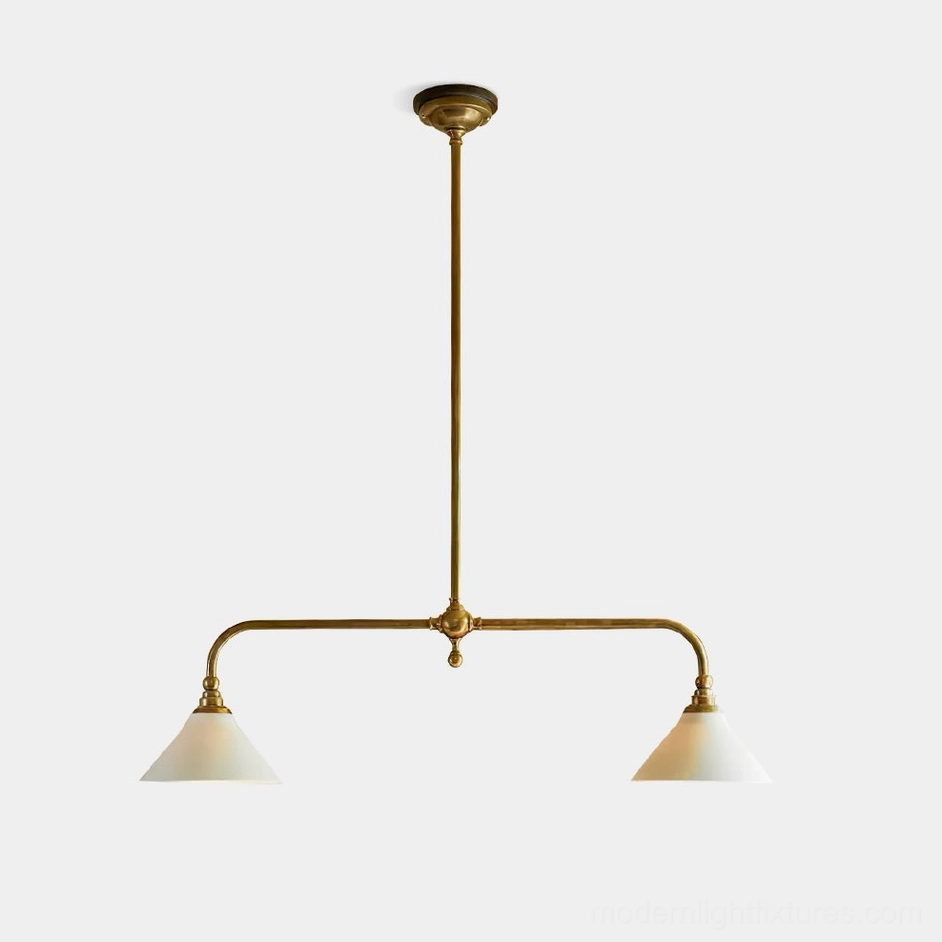 Aged brass two-light linear pendant chandelier with white ceramic conical shades, frontal studio shot showcasing mid-century modern design