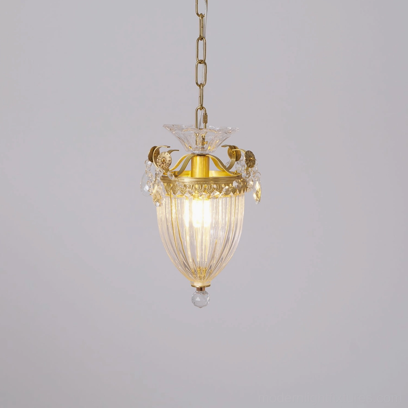 Brass crystal pendant light side view showing ribbed glass shade and decorative crystal ornaments