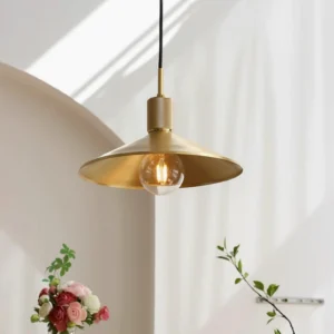 Classic brass pendant lamp 3/4 angle with knurled metal top and decorative exposed bulb in cozy interior setting