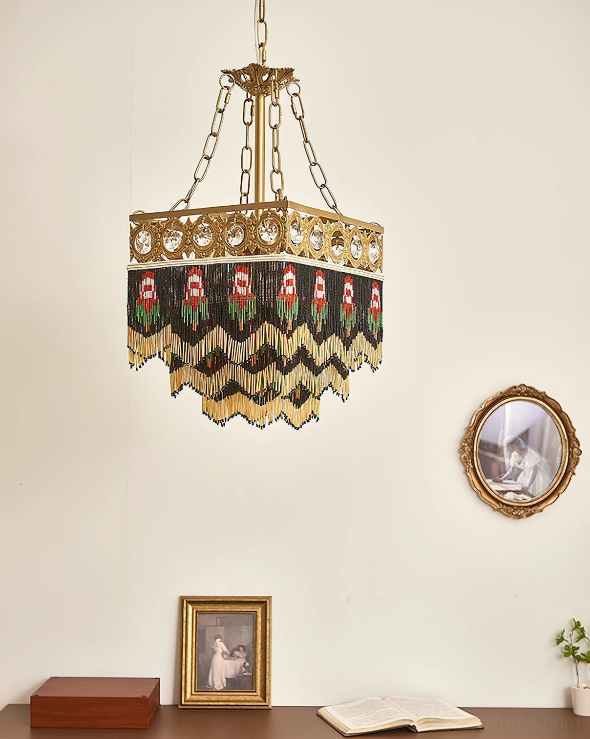 Brass pendant with layered beaded tassels and embroidered details on home wall