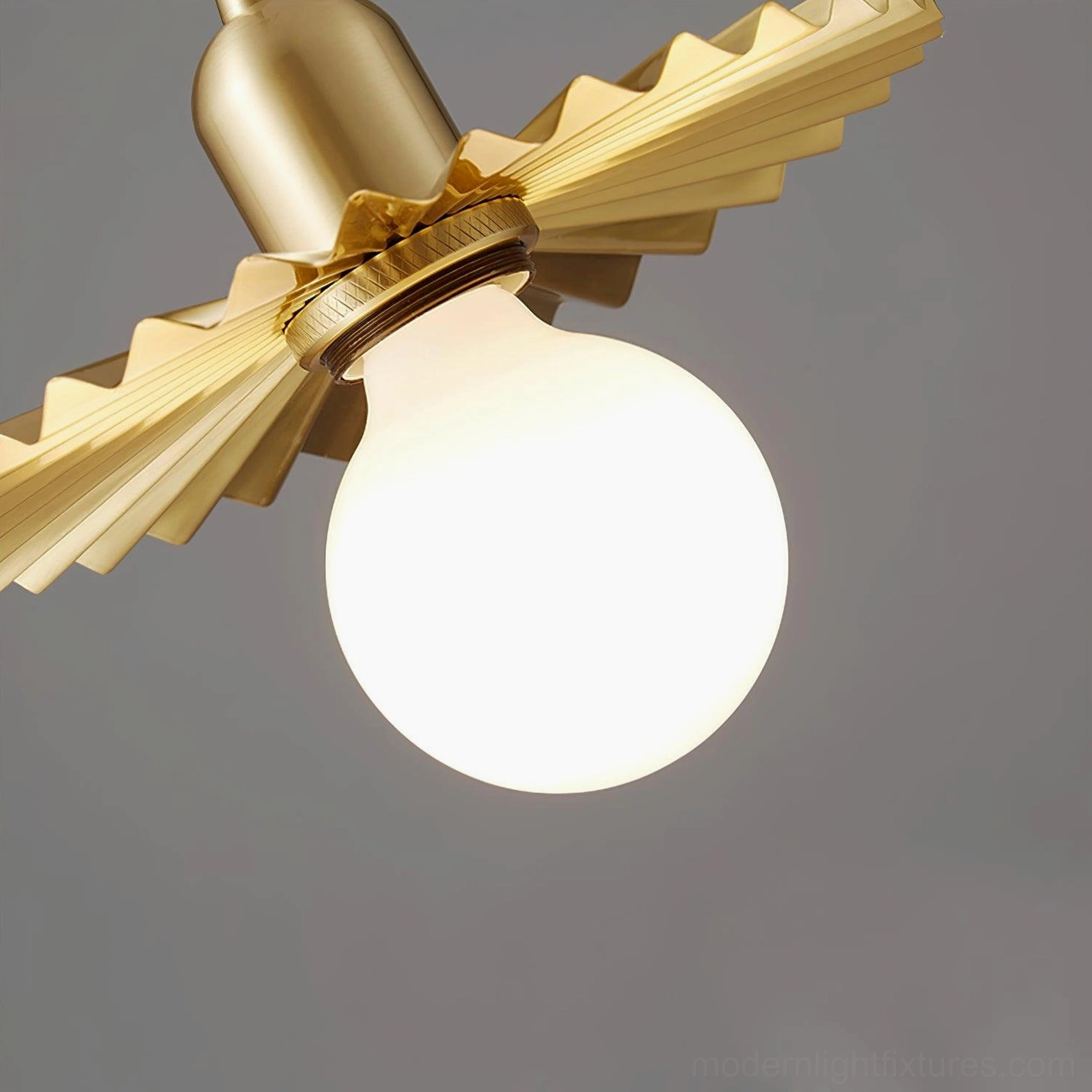 Brass petal pendant light installation in high-end retail boutique ceiling with modern fixtures